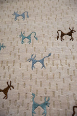 Textured beige Indian Folk Art carpet with stylized art silk teal and brown animals.