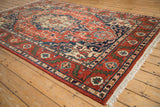 Angled view of a vintage Heriz design rug highlighting its plush pile and detailed geometric border.