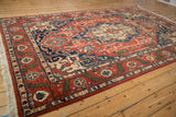 Vintage Indian Heriz design carpet seen from a high angle, displaying its full rust and cobalt blue pattern.