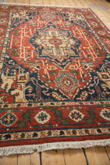 Low-angle shot highlighting the full, plush pile of a vintage Heriz design carpet.