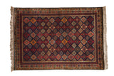 Vintage Indian rug with a diamond lattice field and starburst border in navy, red, and gold.