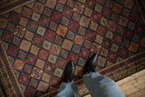 Overhead view of the rich, geometric lattice pattern of a vintage Indian Jaff Kurd design rug.
