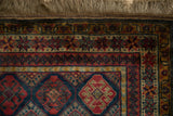 The intact side cord selvage and thick fringe alongside the repeating starburst main border.