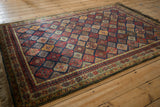 Angled view of a vintage Indian Jaff Kurd rug, showcasing the rich sheen on its geometric pattern.