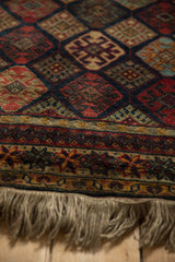 Detailed view of the repeating starburst border in saffron gold and red, with full natural fringe.