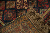 Close-up of a vintage Indian rug's corner showing the hand-knotted back, selvage, and fringe.