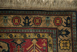 Full pile and original fringe on the corner of a vintage Indian Kazak rug with a detailed floral border.