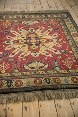 Low angle view across the full pile of a vintage Kazak rug with a starburst medallion.