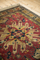 Vintage Kazak rug corner showing the full pile, starburst medallion, and detailed border.