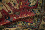 The full, plush pile of a vintage Kazak rug's corner in rust, navy, and gold.