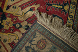 Folded corner of a vintage Kazak rug with its thick pile, hand-knotted back, and neat ivory fringe.