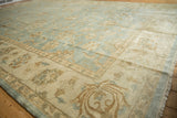 Indian Oushak design carpet's glossy pile with powder blue field and beige serrated palmettes.