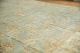 Curvilinear palmettes and delicate vinery in powder blue and beige on an Oushak pile.