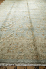 Lustrous pile and fringe of the Indian Oushak rug with powder blue, beige palmette designs.