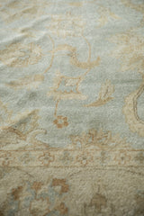 High luster pile of an Indian Oushak rug showing powder blue and beige floral motifs.