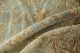 Lustrous pile of a vintage Indian Oushak rug showing powder blue and beige floral vinery.