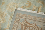 Indian Oushak carpet corner revealing tight hand-knotted weave, secured white fringe, and glossy pile.