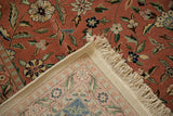 Corner of the hand-knotted Tabriz carpet showing the dense pile, woven back, and clean ivory fringe.