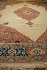 Floral corner spandrel and navy border of a vintage Tabriz design carpet against an ivory field.
