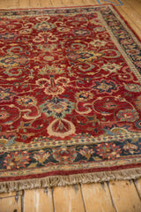 Rich cherry red wool pile and neat ivory fringe on the corner of a vintage Agra carpet.