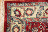 Full wool pile and geometric borders seen on the corner of a vintage Indian Heriz carpet.