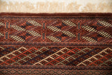 Corner detail of the vintage Bokhara carpet, showing the plush wool pile and intact ivory fringe.