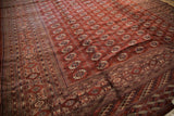 The multi-banded geometric border and secured end of a vintage hand-knotted Bokhara carpet.