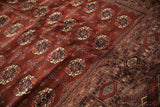 Plush wool pile of a vintage Bokhara carpet with detailed gul medallions and intricate borders.
