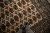 Repeating gul medallions on the plush, lustrous wool pile of a vintage Bokhara carpet.