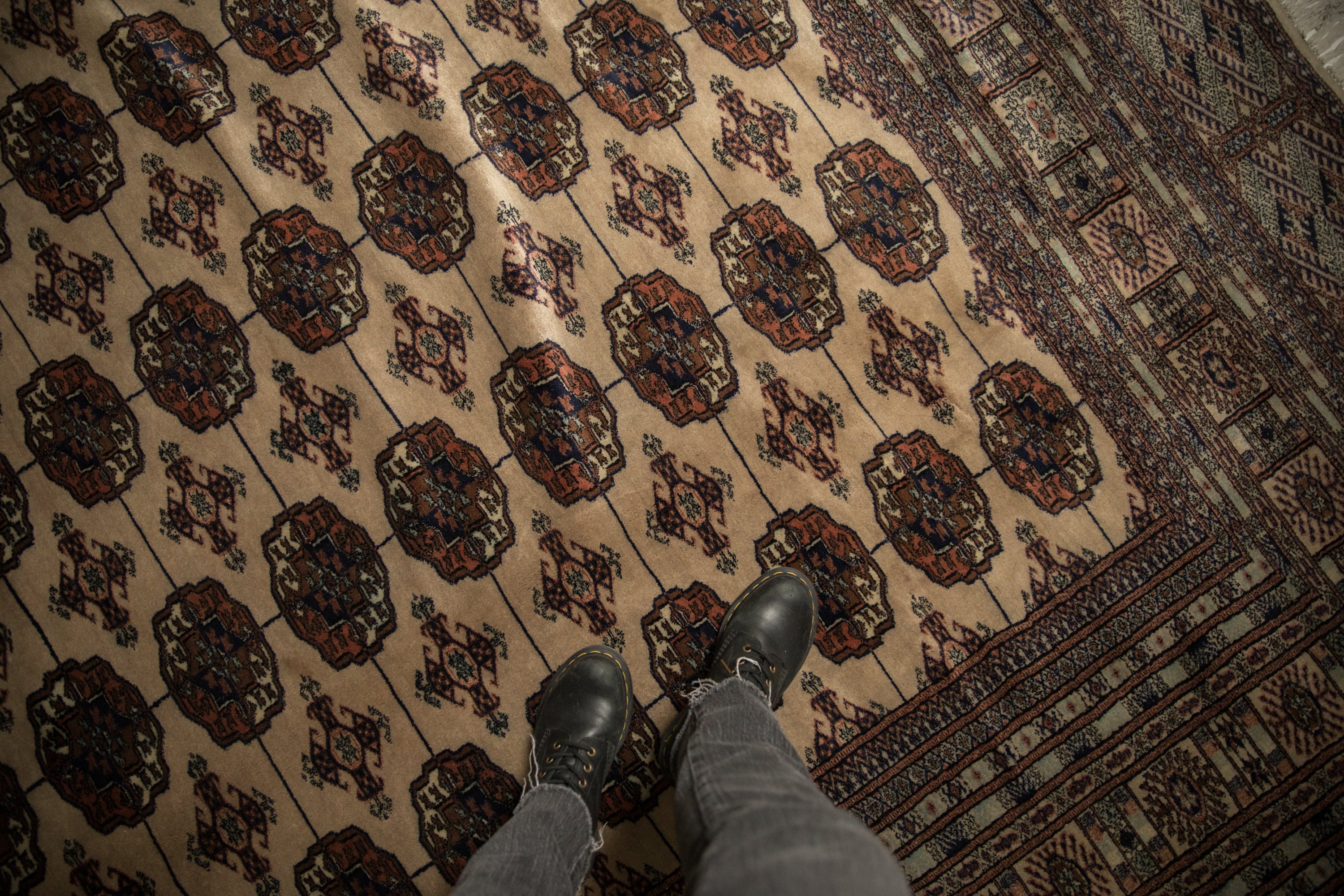 Repeating gul medallions on the plush, lustrous wool pile of a vintage Bokhara carpet.