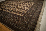 Corner of a fine Bokhara carpet showing the detailed geometric border and original side selvage.