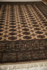 Lustrous sheen across the repeating gul medallions of a hand-knotted vintage Bokhara carpet.