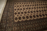 Fine Bokhara carpet corner, showing the lustrous wool pile and detailed geometric border.