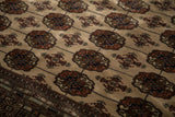 Low light highlights the plush texture and high sheen of the Bokhara carpet's wool pile.