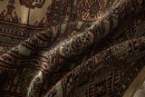 Soft folds in a vintage Bokhara carpet showing the plush, long-stapled wool and high sheen.