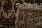 The hand-knotted foundation, plush pile, and ivory fringe of a fine vintage Bokhara carpet.