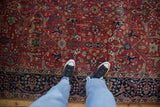 Overhead detail of the full pile on a vintage Agra carpet, showing brick red and navy blue Samovar motifs.