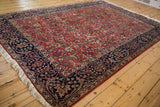 Angled perspective of a vintage Agra carpet, highlighting its full pile and brick red field.