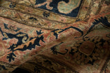 High luster wool pile displaying curvilinear floral arabesques in rich terracotta, indigo, and gold tones.