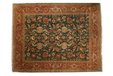 Vintage Serapi design carpet featuring a terracotta turtle border around a forest green floral field.