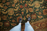 A view from above of the intricate floral pattern on a high-luster vintage Serapi wool carpet.
