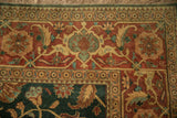 Elaborate turtle samovar main border in terracotta, jade, and gold on a vintage Indian carpet.