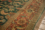 A detailed view of the vintage carpet's turtle samovar border, green vinery field, and fringe.