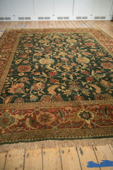 A low angle shot displaying the lustrous wool pile and floral patterns of a vintage Serapi design carpet.