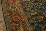 Terracotta turtle border and green floral field on a lustrous hand-knotted vintage carpet.