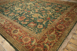 Corner detail of the vintage carpet's lustrous wool pile, terracotta border, and original fringe.