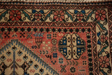 Floral border and geometric field motifs on the hand-knotted corner of a vintage Abadeh rug.