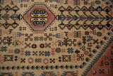 Close-up showing the intricate geometric tribal motifs and dense pile of a vintage Abadeh rug.