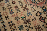 Angled detail of a vintage Abadeh rug's full pile, showing small geometric and stylized bird motifs.