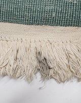 Aqua green vintage Japanese Peking rug's ivory edge and fringe with light staining.